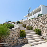 12 Hermes House steps to the pool terrace and summer kitchen, dining area.