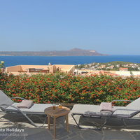 01 Petalouda main terrace with sunbeds and sea view.