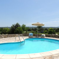 03 Adelphi pool surrounded by orange trees and countryside.