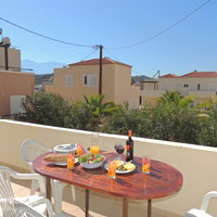 09 Anastasia downstairs dining terrace with pool behind palms