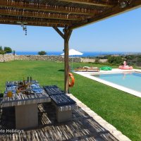 08 Boutique House outside dining area and pool with sea view.