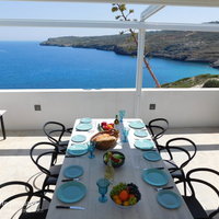 08 Hermes House poolside dining area with sea view.