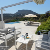 09 Hermes House poolside lounging area with canopy for optional shade.