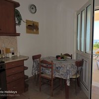 11 Nostalgia kitchen with door to outside dining area and pool terrace.