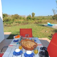 08 Plane Tree House shaded dining area with view to Aptera Turkish Fort.